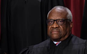 (FILES) In this file photo taken on October 7, 2022 US Supreme Court Justice Clarence Thomas poses for the official photo at the Supreme Court in Washington, DC. - Thomas defended himself on April 7, 2023 over accusations that he accepted years of luxury travel trips from a Republican billionaire, saying that it was "personal hospitality" that did not need to be registered. Staunch conservative Thomas was a guest of megadonor Harlan Crow for yachting in New Zealand, private jet flights across the globe and regular stays at Crow's properties in the United States, the ProPublica news outlet reported. (Photo by OLIVIER DOULIERY / AFP)