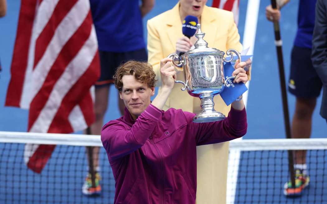 Italy's Jannik Sinner holds the trophy after winning his men's final match against USA's Taylor Fritz on day fourteen of the US Open tennis tournament at the USTA Billie Jean King National Tennis Center in New York City, on September 8, 2024. (Photo by CHARLY TRIBALLEAU / AFP)