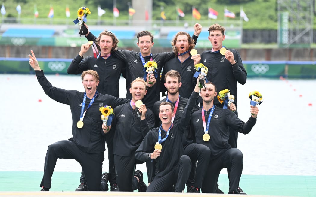 Gold medalists New Zealand's Thomas Mackintosh, Hamish Bond, Tom Murray, Michael Brake, Daniel Williamson, Phillip Wilson, Shaun Kirkham, Matt Macdonald and coxswain Sam Bosworth  on the podium following the men's eight final during the Tokyo 2020 Olympic Games