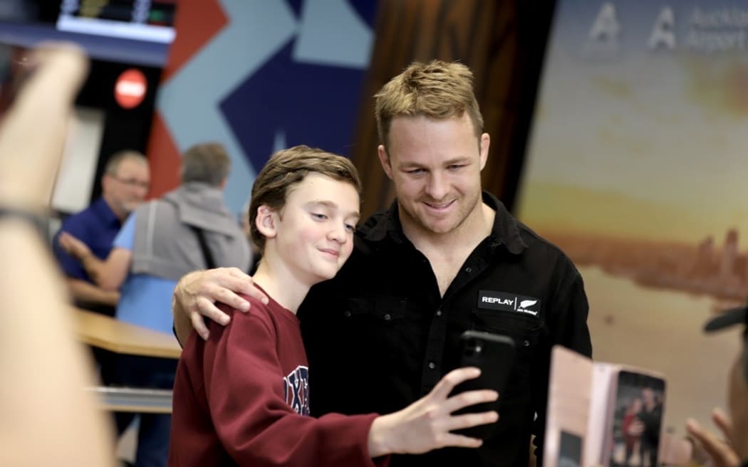 Sam Cane and fan at Auckland Airport