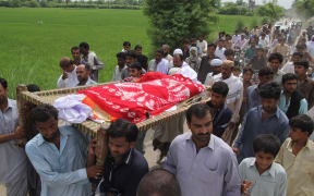Pakistani relatives and residents carry the coffin of social media celebrity, Qandeel Baloch during her funeral in Shah Sadar Din village,