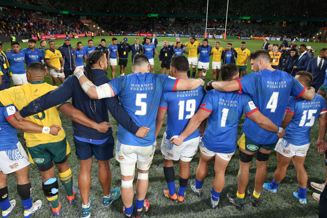 The Manu Samoa and Wallabies players pray together post-match.