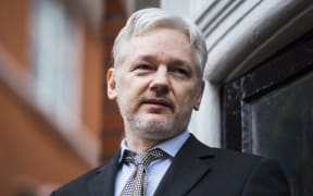 WikiLeaks founder Julian Assange addresses the media from the balcony of the Ecuadorian embassy in central London on February 5, 2016.