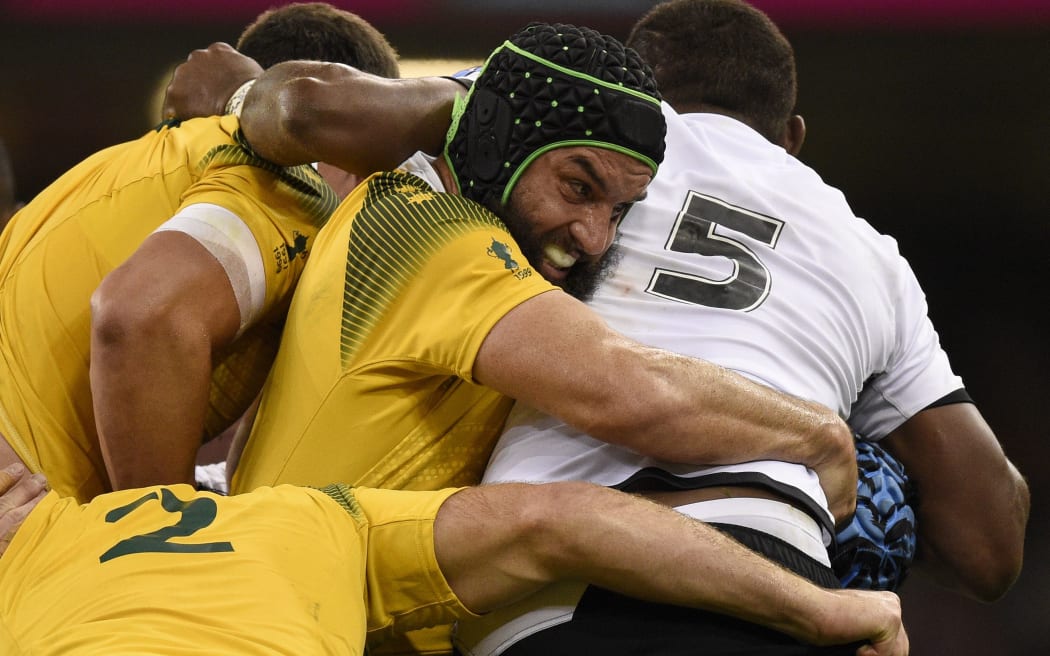 Australian flanker Scott Fardy tackles Fijian flanker Peceli Yato during the 2015 Rugby World Cup between Australia and Fiji at the Millennium stadium.