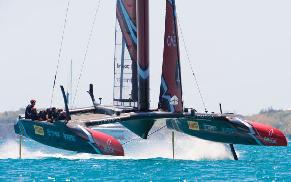 Emirates Team New Zealand rounds the top mark ahead of Oracle Team USA in race four on day two of the America's Cup.