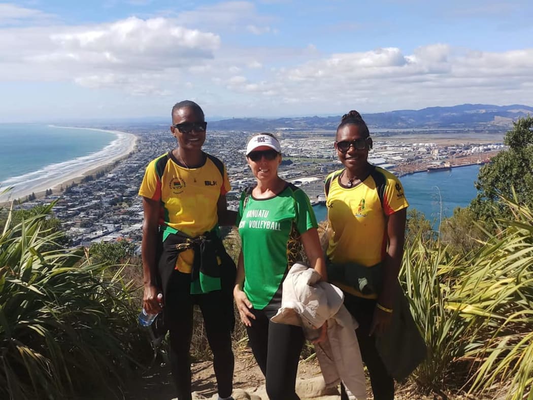 Pacific Games gold medallists Miller Pata and Sherysyn Toko with Vanuatu Volleyball President Debbie Masauvakalo.