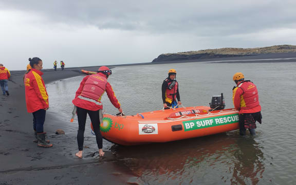 Surf lifesaving teams from Raglan and Taranaki prepare to enter the water at Marokopa to start a coastline search from the ocean.