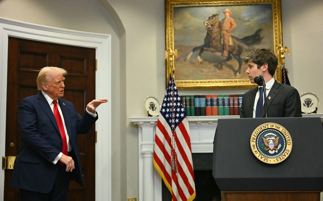 US President Trump gestures as CEO of Open AI Sam Altman speaks in the Roosevelt Room at the White House on January 21, 2025, in Washington, DC. (Photo by Jim WATSON / AFP)
