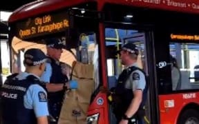 Police seen on Queen Street on Thursday night, putting what appears to be a machete into an evidence bag.