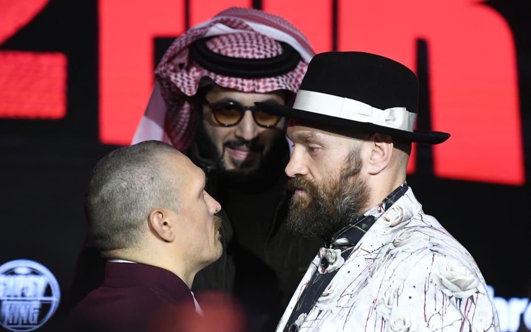 Ukraine's Oleksandr Usyk and Britain's Tyson Fury face off during a press conference ahead of their undisputed heavyweight world championship rematch, in Riyadh on 20 December 2024.
