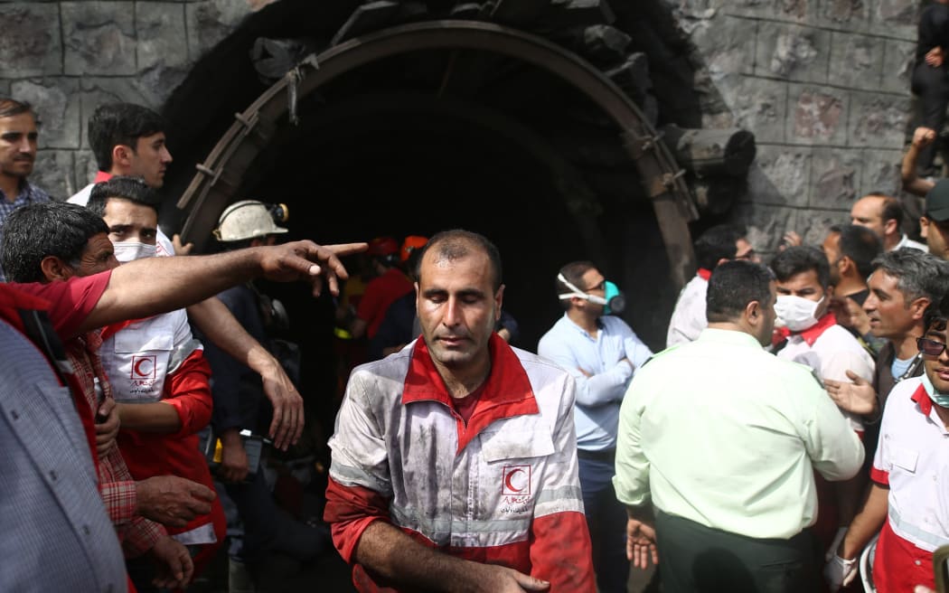 Rescue workers gather at the scene following an explosion in a coal mine in Azadshahr, in northern Iran, leaving dozens of miners trapped on May 3, 2017.