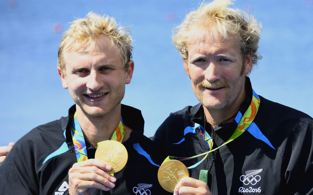 New Zealand's Eric Murray (R) and New Zealand's Hamish Bond (R) celebrate with their gold medals on the podium of Men's Pair final rowing competition at the Lagoa stadium during the Rio 2016 Olympic Games in Rio de Janeiro on August 9, 2016.