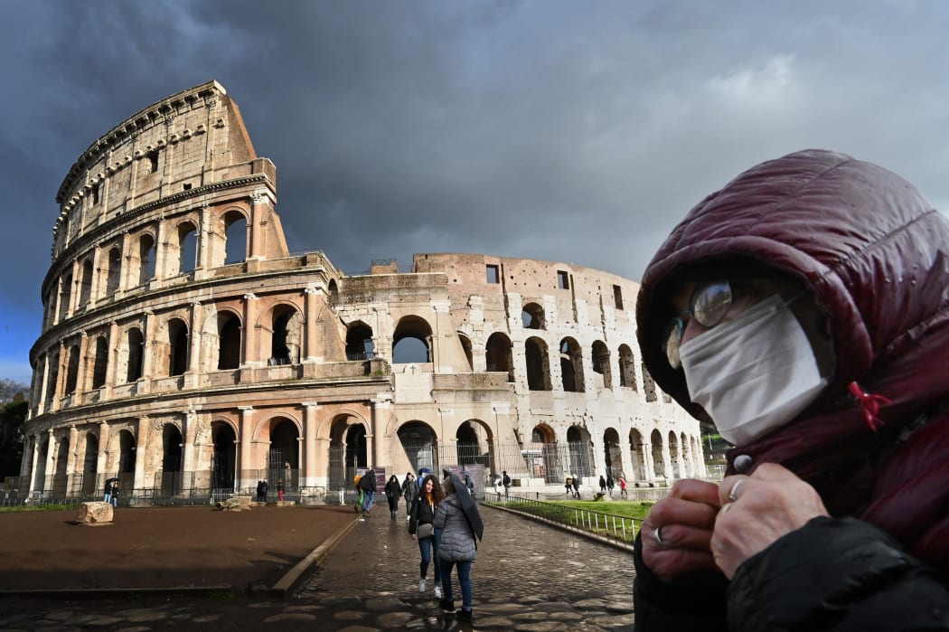 Italy's popular tourist spots like the Colosseum in Rome are nearly deserted as a nationwide ban on public gatherings takes effect.