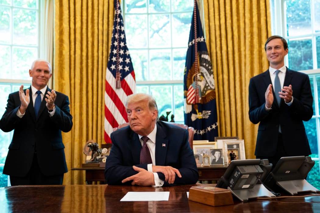 US President Donald Trump, flanked by Vice President Mike Pence (left) and Advisor Jared Kushner, announcing that Bahrain will establish diplomatic relations with Israel, at the White House in Washington, DC on 11 September, 2020.