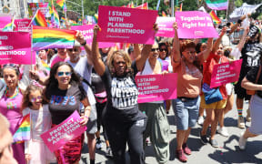 Protesters hold signs supporting Planned Parenthood at the 53rd annual Pride Parade, at New York City's Fifth Avenue on 26 June, 2022.