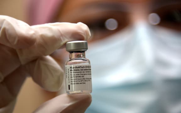 A nurse holds a vial of the Pfizer vaccine at the Pablo Arturo Suarez Hospital in Quito on January 21, 2021.