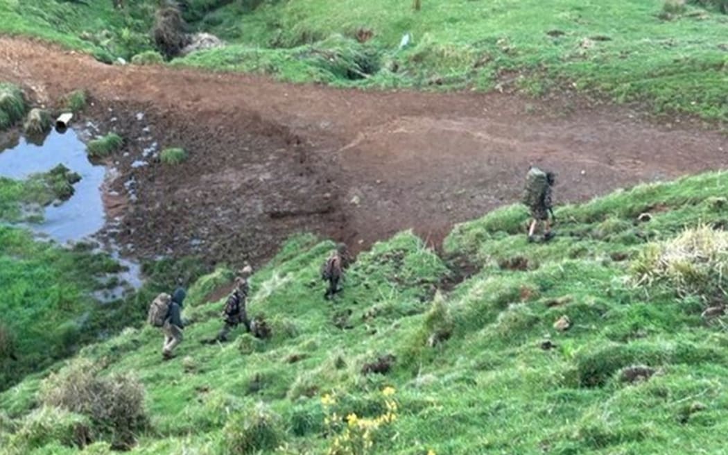 A screenshot from a video appearing to show Tom Phillips and his children.