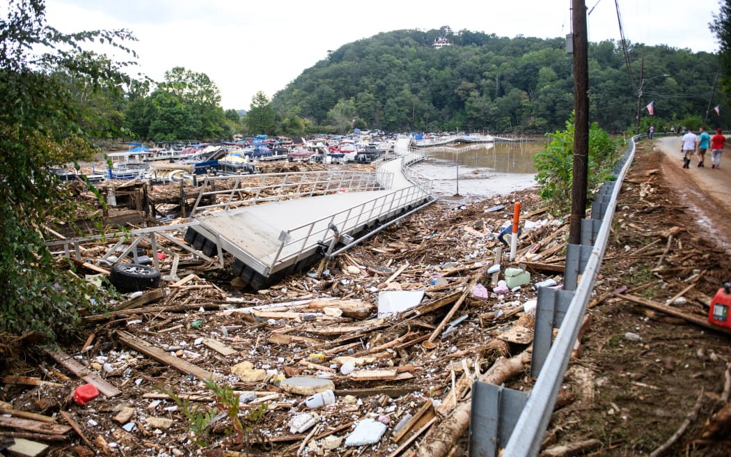 LAKE LURE, NORTH CAROLINA - SEPTEMBER 28: The Rocky Broad River flows into Lake Lure and overflows the town with debris from Chimney Rock, North Carolina after heavy rains from Hurricane Helene on September 28, 2024, in Lake Lure, North Carolina. Approximately six feet of debris piled on the bridge from Lake Lure to Chimney Rock, blocking access.   Melissa Sue Gerrits/Getty Images/AFP (Photo by Melissa Sue Gerrits / GETTY IMAGES NORTH AMERICA / Getty Images via AFP)