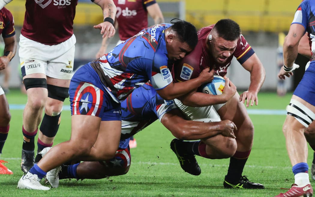Saula Maa'u, right, is tackled by Hurricanes Xavier Numia during the Hurricanes v Highlanders, Super Rugby Pacific match, Sky Stadium, Wellington.