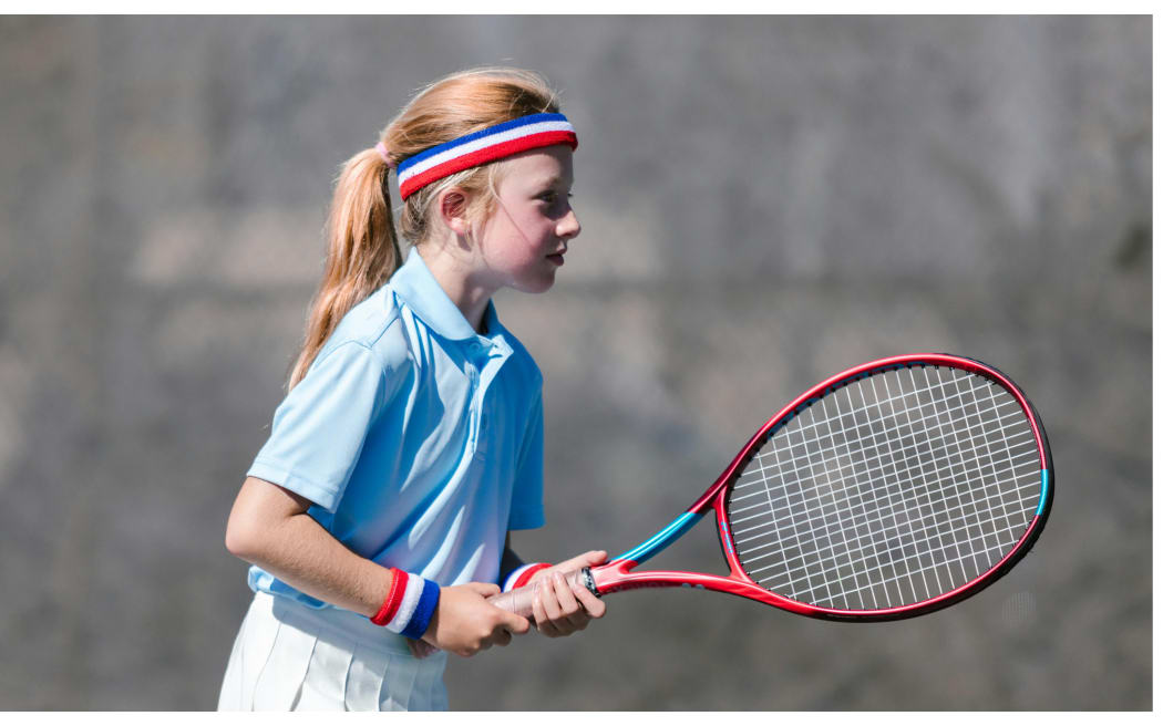 child playing tennis