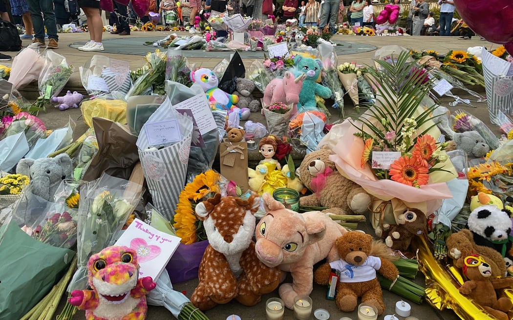 Floral tributes and soft toys are laid following a vigil in Southport, northwest England, on July 30, 2024, a day after a deadly child knife attack. Violent clashes broke out in the northern England town where a knife attack claimed the lives of three children, with around 100 protesters lighting fires and battling police. A 17-year-old male suspect from a nearby village arrested shortly after the incident remained in custody, police added, as they warned against speculating about his identity or details of the investigation. (Photo by Roland LLOYD PARRY / AFP)