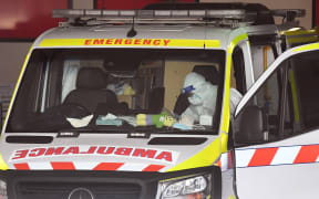 An ambulance is cleaned at Royal Melbourne Hospital in Melbourne yesterday, as the state's health system struggles with record high cases of Covid-19.
