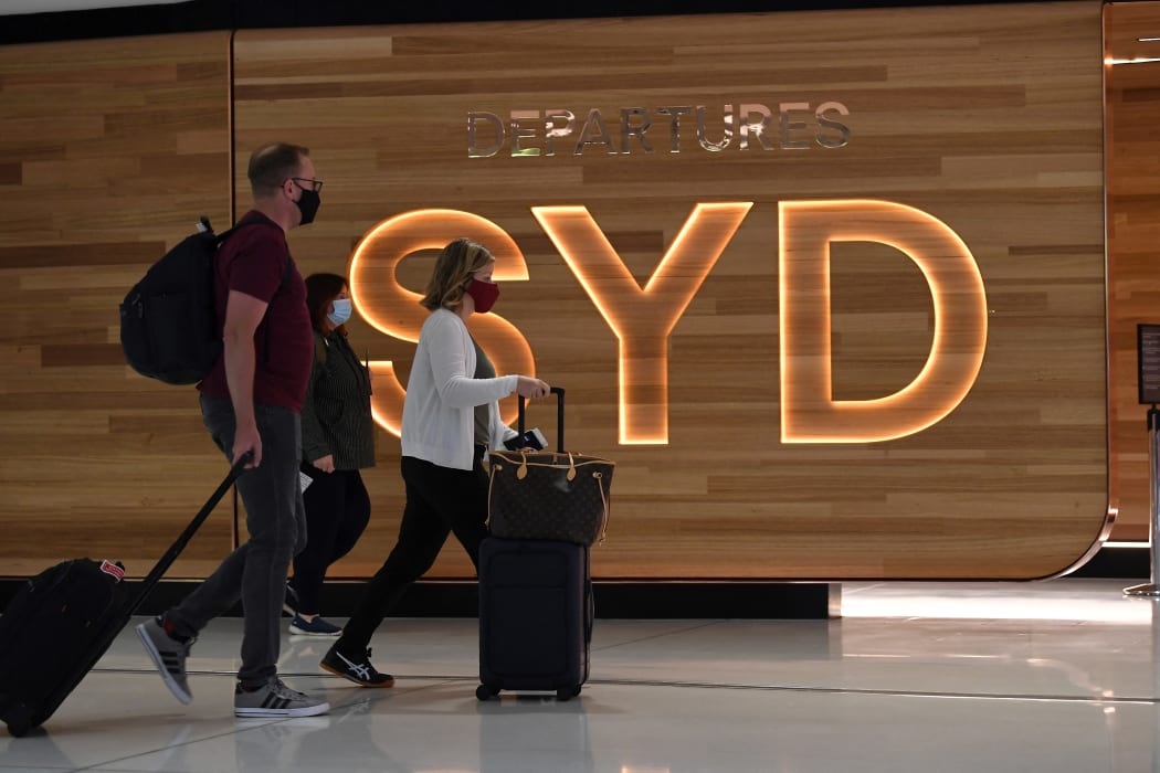 Passengers walk to board a plane at Sydney International Airport on 1 November 2021.