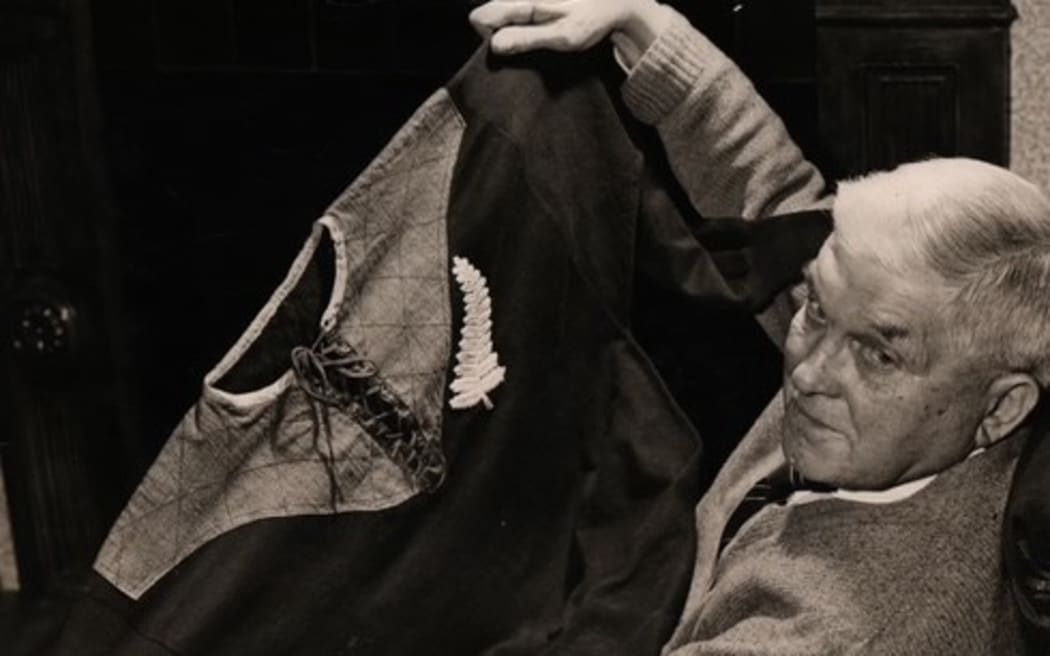 The late Arthur Goddard shows the All Blacks jersey he was given after his town's team Cheltenham played against New Zealand in 1905.
