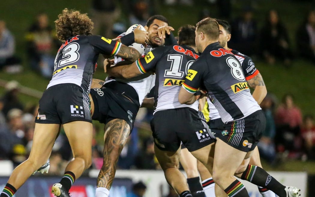 Warriors forward Adam Blair is hit in a big tackle against the Panthers.