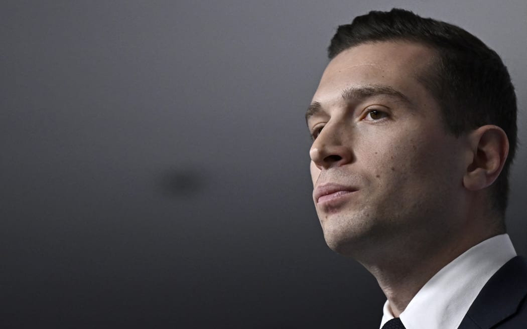 French far-right Rassemblement National (RN) political party President and lead MEP Jordan Bardella looks on as he gives a speech during the results evening of the first round of the parliamentary elections in Paris on June 30, 2024. France's far right won the first round of pivotal legislative elections on June 30, 2024, with the centrist forces of France's President coming in only third behind the left after the highest turnout in over four decades, estimates said. (Photo by JULIEN DE ROSA / AFP)