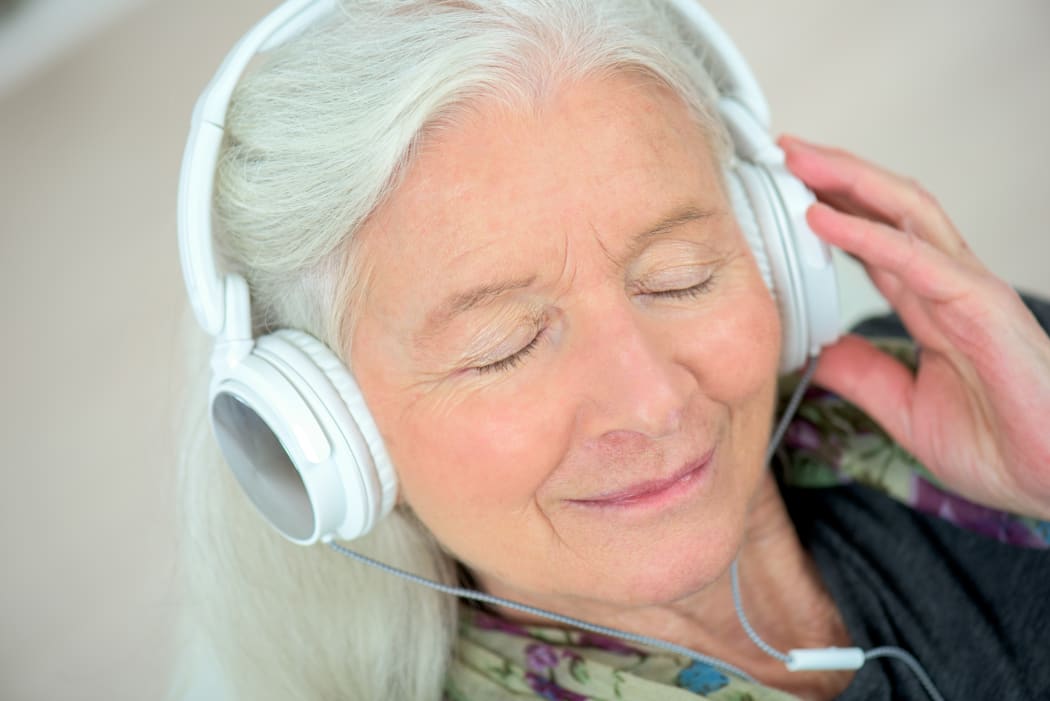 elderly woman with headphones