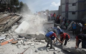 People search through debris for anyone  who may be trapped in falling buildings.