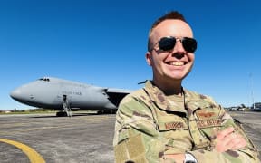 US Air Force Lieutenant Sean Murray poses in front of the C-5M Super Galaxy.