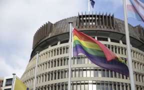 Rainbow flag flies outside Parliament.