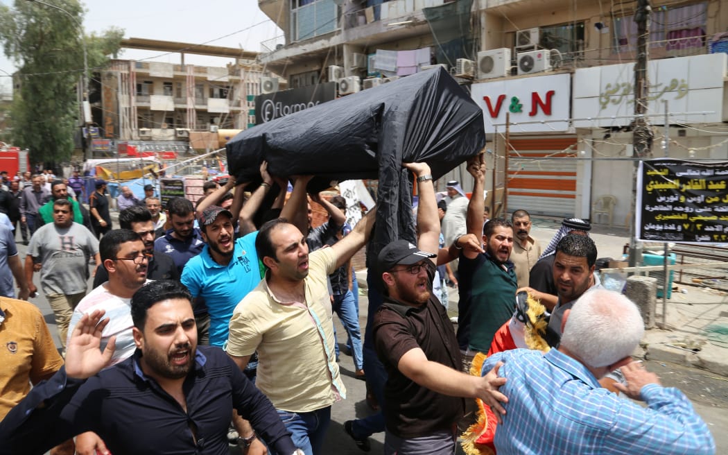 The funeral of one of scores of people killed in a suicide attack on Baghdad's Karrada district.