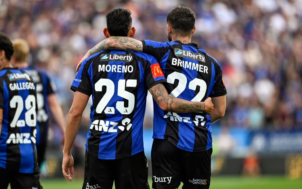 Neyder Moreno and Jake Brimmer of Auckland FC embrace.