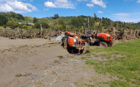 Thick silt and upended tractors lie at the front of Pheasant Farm, Esk Valley, in the wake of Cyclone Gabrielle.