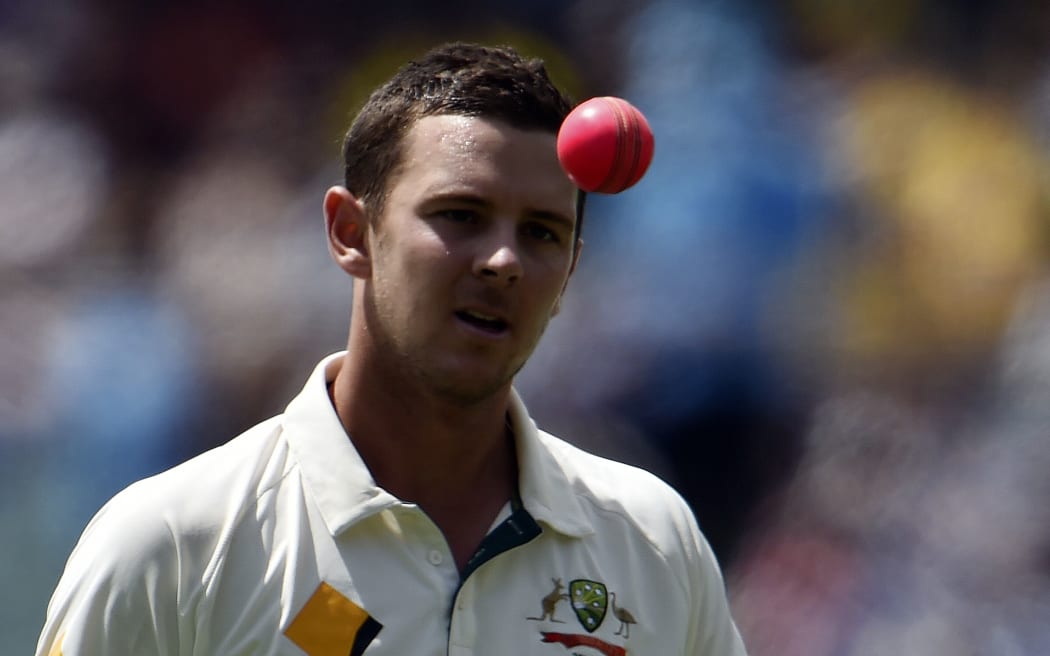 Australia's paceman Josh Hazlewood tosses a pink ball as he gets ready to bowl during the first day-night cricket Test match at the Adelaide Oval on November 27, 2015.