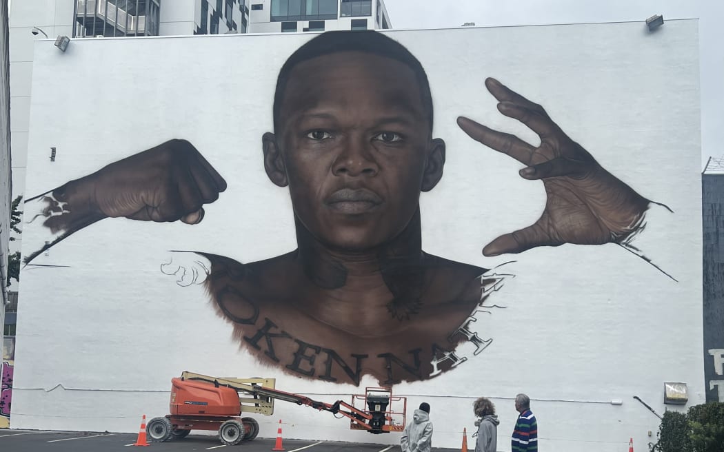 Kara Rickard and Mark Williams visit Owen Dippie's mural of MMA star Israel Adesanya