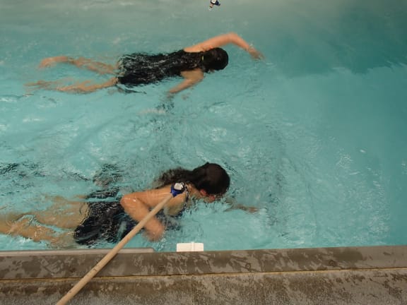 Two girls swimming