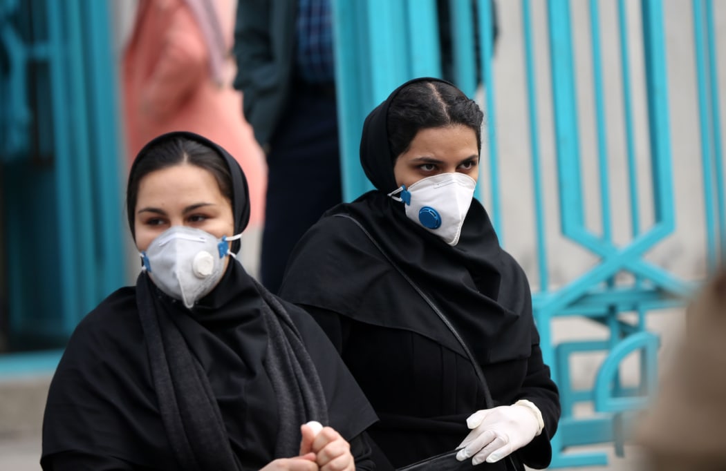 People wear masks after deaths and new confirmed cases revealed from the coronavirus in Tehran, Iran.