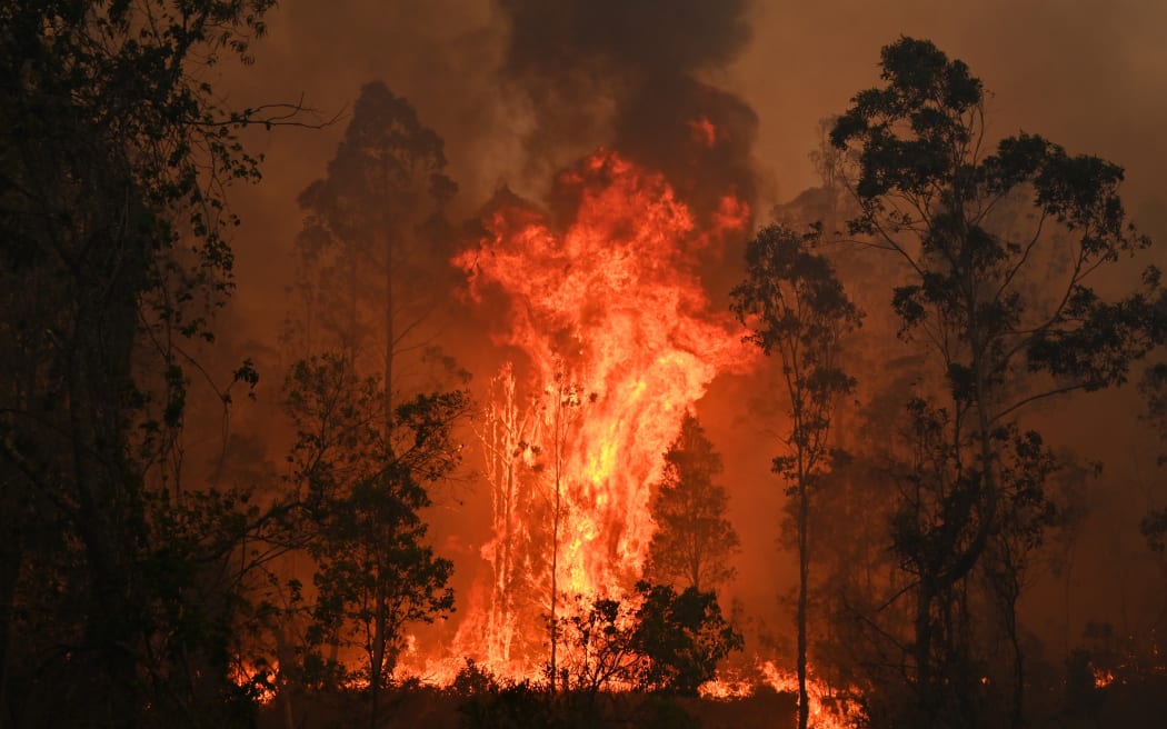 A fire rages in Bobin, 350km north of Sydney on November 9, 2019, as firefighters try to contain dozens of out-of-control blazes that are raging in the state of New South Wales.
