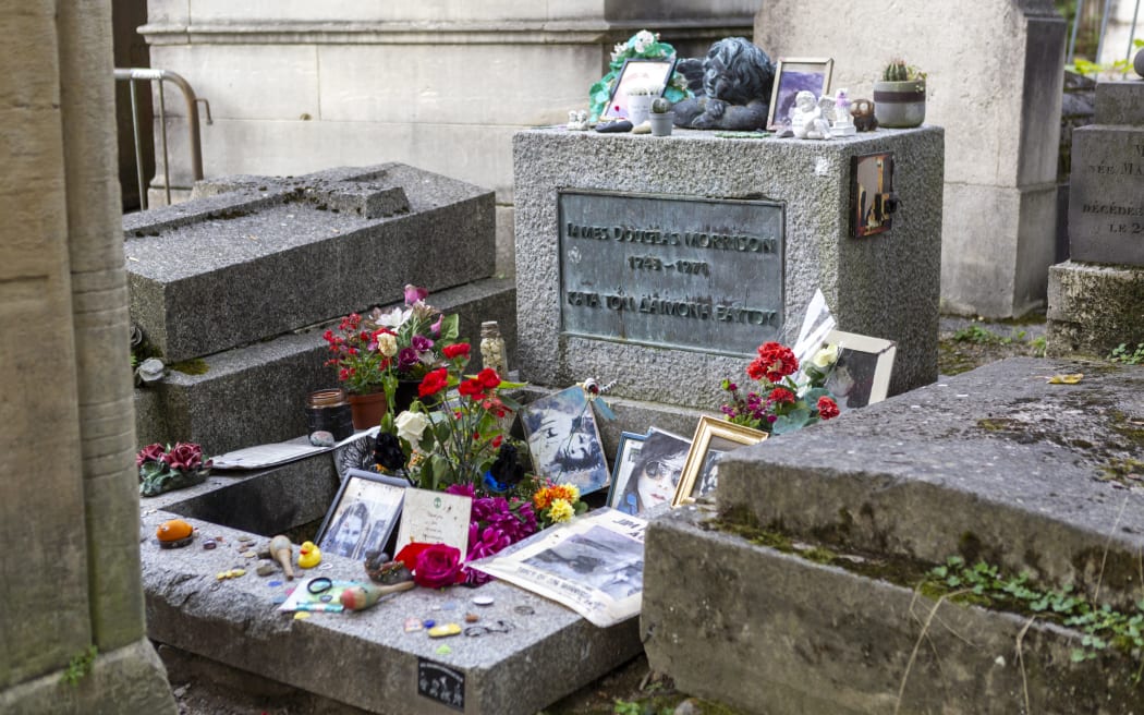 A general view of the tomb of Jim Morrison at Pere Lachaise Cemetery in Paris, France, on September 16, 2024. Paris is known as the 'City of Light,' but it is also home to one of the most visited cemeteries in the world: Pere Lachaise. As the largest cemetery within the city, it is famous for being the final resting place of numerous celebrities and public figures, making it one of the most popular cemeteries in Europe. (Photo by Luis Boza/NurPhoto via Getty Images) (Photo by Luis Boza/NurPhoto) (Photo by Luis Boza / NurPhoto via AFP)