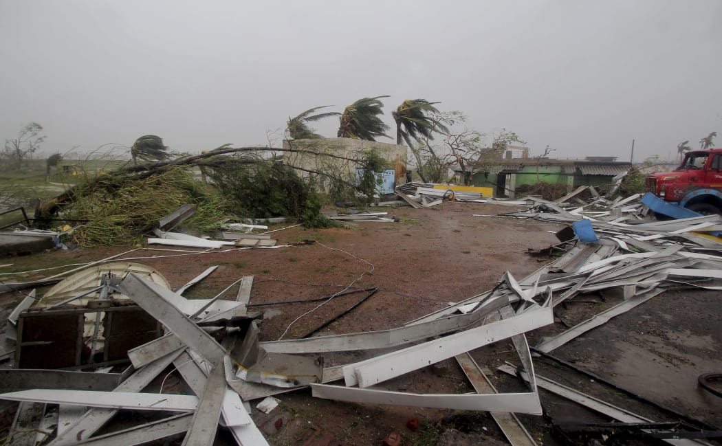 Damaged structures and uprooted tress lie along a road in Puri district after Cyclone Fani hit the coastal eastern state of Odisha, India, Friday, May 3, 2019.