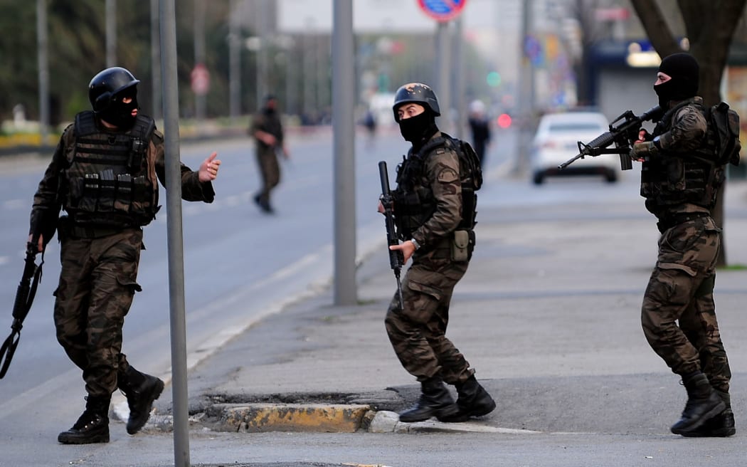 Turkish police special forces take position  after security forces shot dead a female assailant armed with bombs and a gun.