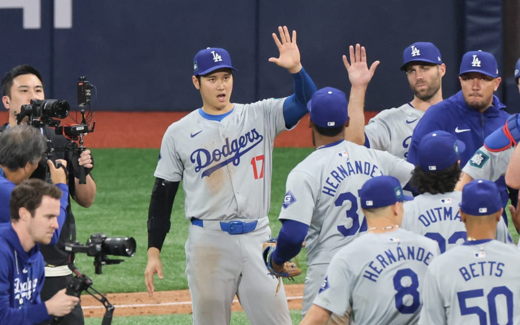 Shohei Ohtani of the Los Angeles Dodgers celebrates with his teammates