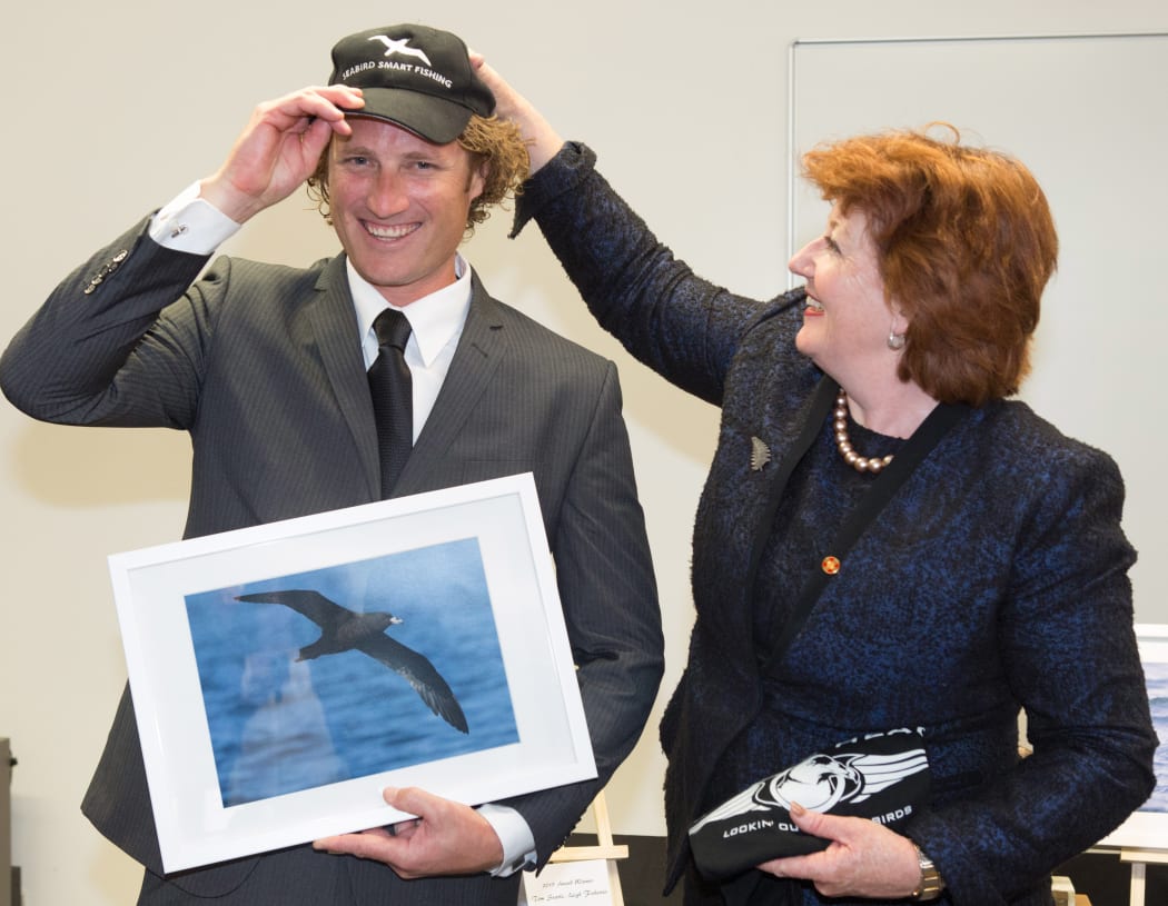 Tom Searle receiving a Seabird Smart award from Conservation Minister Maggie Barry