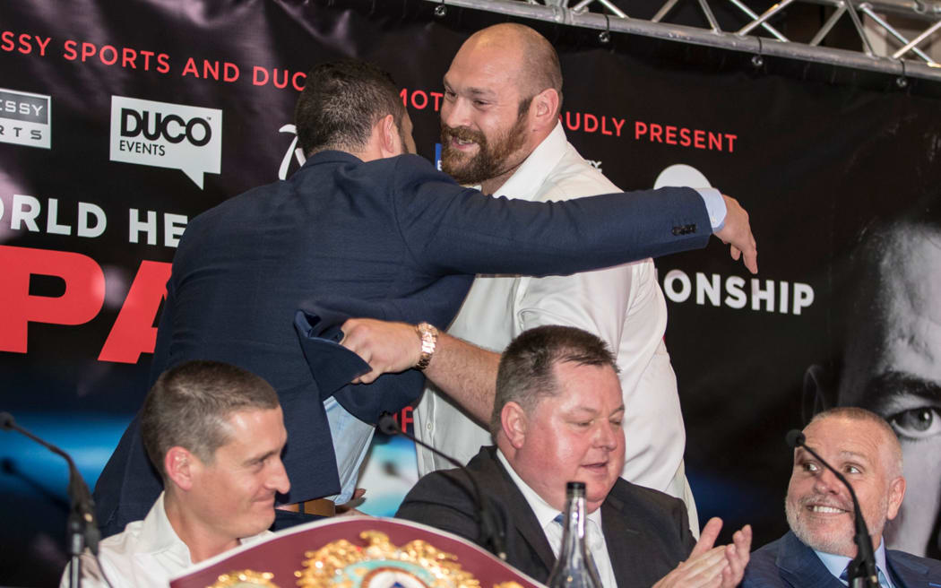 Joseph Parker, left, and Tyson Fury share a hug at the pre-fight press conference for Parker's world title defence against Tyson's cousin Hughie in September, 2017.