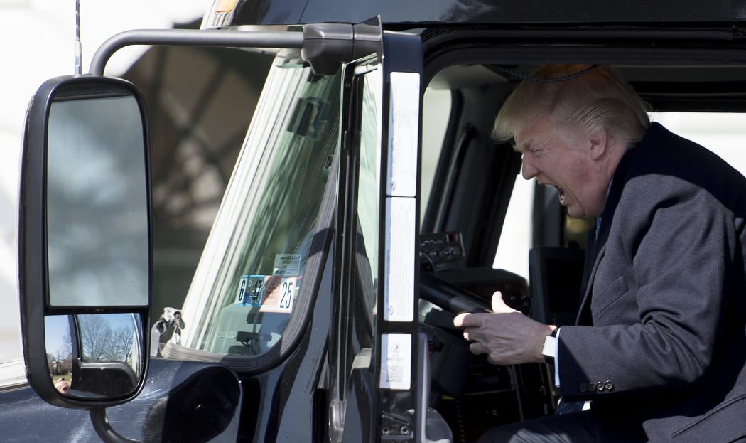US President Donald Trump sits in the drivers seat of a semi-truck as he welcomes truckers and CEOs to the White House in Washington, DC, to discuss healthcare.