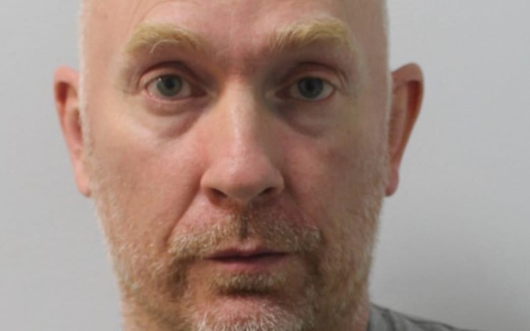(FILES) In this file undated handout picture released by the Metropolitan Police on July 9, 2021, shows British police officer Wayne Couzens, 48, who pleaded guilty to the murder of Sarah Everard, via video link at London's Old Bailey court.